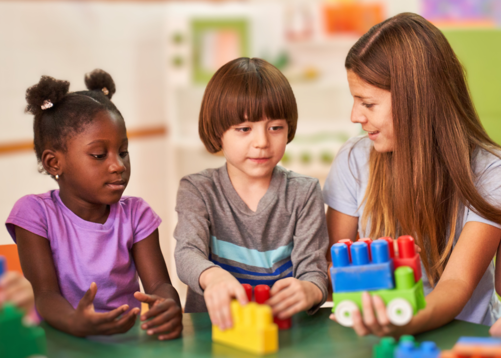 Female teacher working with diverse preschool students